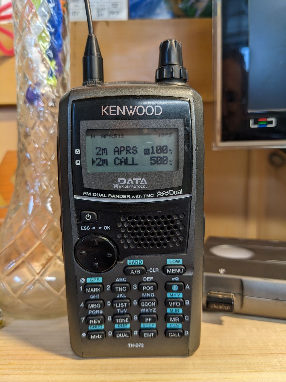 radio sitting on a desk tuned to 2m APRS and 2m CALL memories